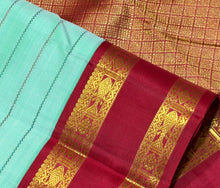 Vaibhogam- Gorgeous Pastel Green with Ganga Jamuna Bottle Green and Arakku Red borders with Neli Veldhari woven beautiful body with fishpet double borders rich pallu and contrast woven blouse