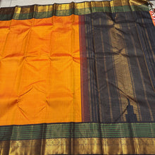 Stunning Mango Yellow with Bottle Green and Black Handwoven Jari Korvai Kanjivaram with striped body rich double side varisai borders with meenakari strips and kamalam motifs and mayilkan bhttas woven in the borders rich pallu and contrast woven blouse