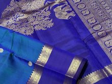 Rama  Bluish Green  with Royal Blue Handwoven Pure Kanjivaram Silk Saree with beautiful deers and peacocks motifs woven body with rettapet borders rich vanasingaram style woven pallu with elephants peacocks under a tree and contrast woven blouse.