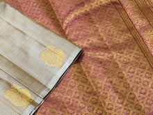 Sahana- Gorgeous Beige with Onion Pink Handwoven Pure 2g Jari Kanjivaram Silk in Half and Half Style with Muthukattam aith buttas woven body with rich onion pink pallu and contrast blouse