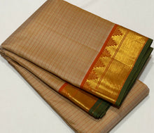 Sahana- Beautiful Biscuit beige with Orange Handwoven Pure Jari Kanjivaram Silk with muthukattam woven body with bawanchi temples and zigzags woven borders with green selvedges rich seer pallu and contrast orange blouse.