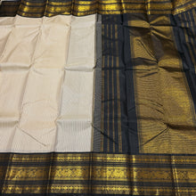 Vaibhogam- Beautiful Offwhite with Black Handwoven Pure2g Jari Korvai Kanjivaram Silk with beautiful striped body with rich borders stunning rich seer pallu and contrast woven beautiful black blouse