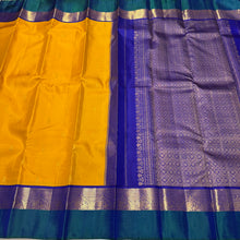 Vaibhogam-Gorgeous Golden Mustard with Peacock Blue and Violetish Blue Buttas Handwoven Pure Jari Korvai Kanjivaram Silk with Spaced borders rich pallu and contrast woven blouse. A very beautiful piece for this wedding season!