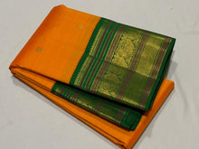 Vaibhogam-Stunning Mango Orange with Emerald Green Handwoven Pure Jari Korvai Kanjivaram Silk with Buttas woven body beautifully woven rich borders pallu and contrast woven green blouse