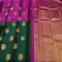 Saranga- Super Gorgeous Bottle Green with Deep Magenta Handwoven Pure Kanjivaram Silk woven in half and half style with muthukattam vertical stripes running vertically all over the body with peacocks woven body rich pallu and contrast woven blouse