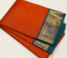 Vaibhogam- Gorgeous Burnt Orange with Peacock Blue Handwoven Pure 2g Jari Korvai Kanjivaram Silk with plain body rich borders gorgeous pallu and contrast woven blouse