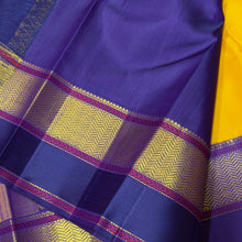Vaibhogam- Gorgeous Yellow with Blue Handwoven Pure 2gJari Korvai Kanjivaram Silk with beautiful gandaberundas woven silk buttas in body with beautiful spaced meenakari woven borders rich pallu and contrast woven blouse