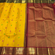 Vaibhogam -Stunning Yellow with Burgundy and BottleGreen Handwoven Pure Jari Korvai Kanjivaram Silk with silk buttas woven beautiful body with rich Gandaberundas woven ganga jamuna borders on both sides with rich pallu and contrast blouse