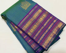 Vaibhogam- Gorgeous Peacock Bluish Green with Purple Handwoven Pure Jari Kanjivaram Silk in Vairaoosi with Buttas woven beautiful body with varisaipet borders rich pallu and contrast purple vairaoosi blouse