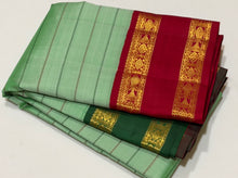 Vaibhogam- Beautiful Pista Green with Ganga Jamuna Borders Handwoven Pure Jari Korvai Kanjivaram Silk in bottle green and deep red with Neliveldhari woven beautiful body with fish woven doublepet borders rich pallu and contrast woven blouse