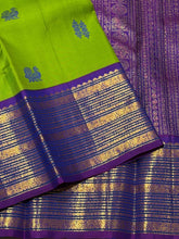 Vaibhogam- Mesmerizing Parrot Green with Violetish Purple Handwoven Pure Jari Korvai Kanjivaram Silk with Pattu buttas woven body with rich borders gorgeous pallu and contrast woven blouse