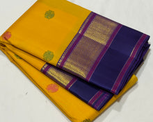 Vaibhogam- Gorgeous Yellow with Blue Handwoven Pure 2gJari Korvai Kanjivaram Silk with beautiful gandaberundas woven silk buttas in body with beautiful spaced meenakari woven borders rich pallu and contrast woven blouse