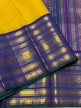 Vaibhogam- Stunning Yellow with Royal Blue Handwoven Pure Zari Korvai Kanjivaram Silk with Buttas Rich Varisaipet Borders gorgeous Meenakari work Pallu and Contrast woven blouse