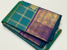 Vaibhogam-Gorgeous Peacock Green with Purple Handwoven Pure Jari Kanjivaram Silk with beautiful Jari checks with elephants and annapakshis woven body with rich borders pallu and contrast jari checked blouse