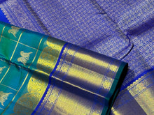 Vaibhogam-Gorgeous Peacock Blue Green with Royal Blue Handwoven Pure Jari Kanjivaram Silk Saree with Rettaikili motifs in Jari Checked body rich borders Pallu and Contrast woven blouse