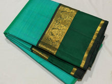 Vaibhogam- Beautiful Light Green with Dark Bottle Green Handwoven Pure Zari Korvai Kanjivaram Silk with beautiful spaced light and dark green double borders rich seer pallu and contrast woven bottle green blouse