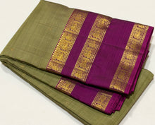Sarasangi- Stunning Elaichi Green with Deep Magenta Buttas Handwoven Pure 2g Jari Korvai Kanjivaram Silk with beautiful doublepet borders rich woven pallu and contrast woven blouse