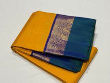 Vaibhogam-Gorgeous Golden Mustard with Peacock Blue and Violetish Blue Buttas Handwoven Pure Jari Korvai Kanjivaram Silk with Spaced borders rich pallu and contrast woven blouse. A very beautiful piece for this wedding season!