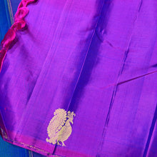 Saranga-Stunning Peacock Blue with Vadamalli Purple Handwoven Pure Jari Kanjivaram Silk in a half and half style woven body with muthukattam vertical stripes running thru the body with peacocks woven body rich pallu and contrast woven blouse.