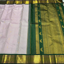 Vaibhogam- Gorgeous Lavendar with Bottle Green Handwoven Pure Jari Kanjivaram Silk with Jari Oosi Kattam Woven Body with Buttas rich Meenakari Work Woven Borders Beautiful Kalashetra Rettaikili buttas woven pallu and contrast woven blouse