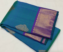 Sahana- Stunning Peacock Bluish Green with Purple Handwoven Pure 2g Jari Kanjivaram Silk with Muthukattam and Buttas woven beautiful body with rich bawanchi borders gorgeous kalakshetra kili pallu and contrast purple blouse