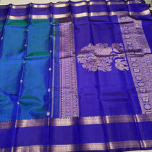 Rama  Bluish Green  with Royal Blue Handwoven Pure Kanjivaram Silk Saree with beautiful deers and peacocks motifs woven body with rettapet borders rich vanasingaram style woven pallu with elephants peacocks under a tree and contrast woven blouse.
