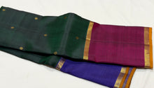Sahana- Stunning Bottle Green with Ganga Jamuna Borders with buttas with contrast kanakambaram Orange Pallu and blouse in a beautiful Handwoven Pure 2g Jari Kanjivaram Silk Beauty