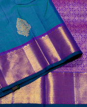 Sahana- Stunning Peacock Bluish Green with Purple Handwoven Pure 2g Jari Kanjivaram Silk with Muthukattam and Buttas woven beautiful body with rich bawanchi borders gorgeous kalakshetra kili pallu and contrast purple blouse