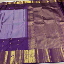 Vaibhogam- Mesmerizing Lavendar with Purple Handwoven Pure 2g Jari KanjivaramSilk with Jarioosi checked body with beautiful mayil chakram motifs woven middle borders with beautiful long and short borders pallu and contrast woven blouse