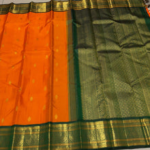 Vaibhogam- Stunning Orange with Bottle Green Handwoven Pure Zari Korvai Kanjivaram Silk with Buttas woven body with rich Borders gorgeous pallu and contrast green blouse
