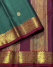 Vaibhogam- Gorgeous Bottle Green with Deep Maroon Handwoven Pure 2g Jari Korvai with Buttas Kanjivaram Silk with Self striped body with beautiful small borders rich pallu and contrast woven maroon blouse