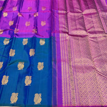 Saranga-Stunning Peacock Blue with Vadamalli Purple Handwoven Pure Jari Kanjivaram Silk in a half and half style woven body with muthukattam vertical stripes running thru the body with peacocks woven body rich pallu and contrast woven blouse.