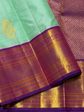Vaibhogam- Beautiful Pista Green with Purple Handwoven Pure Jari Korvai Kanjivaram Silk with Buttas woven body rich borders pallu and contrast woven blouse