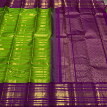Vaibhogam- Stunning Parrot Green with Purple Handwoven Pure Zari Korvai Kanjivaram Silk with Beautiful Jari Veldhari woven body with rich varisaipet borders gorgeous palli and contrast veldhari stripes woven blouse