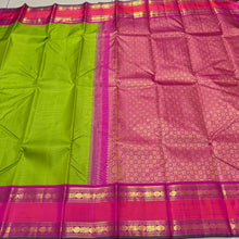 Vaibhogam -Gorgeous Parrot Green with Pink Vairaoosi Handwoven Pure Korvai Kanjivaram Silk with doublepet borders in pink and orange shades with rich pallu and contrast Vairaoosi woven beautiful blouse