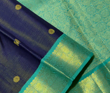Vaibhogam- Gorgeous Navy Blue with Teal Handwoven Pure 2g Jari Korvai Kanjivaram Silk with Vairaoosi body with mayil chakram motifs woven body with beautiful borders rich pallu and contrast Vairaoosi woven blouse In teal