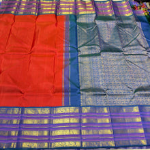 Vaibhogam- Stunning Burnt Orange Red with Peacock Blue Handwoven Pure Jari Korvai Kanjivaram Silk with Plain body rich varisaipet borders beautiful peacock blue pallu and contrast woven blouse