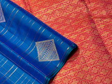 Gorgeous Mayilkazhuthu Blue with Dual tone Orange Pink Borderless Handwoven Pure Jari Kanjivaram Silk with Rich Meenakari Motifs woven Jari checked body with gorgeous Pallu and contrast woven blouse