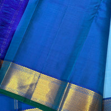 Nayaki- Beautiful Handwoven Pure Jari Kanjivaram Silk in a pastel blue with peacock blue combination with self striped body , rich mayilkan woven bawanchi borders rich seer pallu and contrast blouse