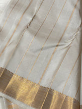 Gorgeous Offwhite with Gold Combination in Handwoven Pure Kanjivaram Silk Saree with rich Peacock driven chariot motifs woven all over the body with beautiful and intricate borders rich woven pallu and blouse with Zari strips