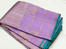 Sahana-Mesmerizing Lavendar with Turquoise Green Brocade Handwoven Pure Jari Kanjivaram with Jari checked borders with peacocks woven with rich turquoise pallu and contrast woven blouse.