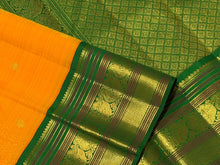 Vaibhogam-Stunning Mango Orange with Emerald Green Handwoven Pure Jari Korvai Kanjivaram Silk with Buttas woven body beautifully woven rich borders pallu and contrast woven green blouse