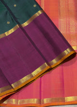 Sahana- Stunning Bottle Green with Ganga Jamuna Borders with buttas with contrast kanakambaram Orange Pallu and blouse in a beautiful Handwoven Pure 2g Jari Kanjivaram Silk Beauty
