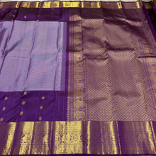 Vaibhogam- Mesmerizing Lavendar with Purple Handwoven Pure 2g Jari KanjivaramSilk with Jarioosi checked body with beautiful mayil chakram motifs woven middle borders with beautiful long and short borders pallu and contrast woven blouse