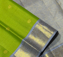 Vaibhogam- Gorgeous Parrot Green with Grey Handwoven Pure 2g Jari Korvai with Vairaoosi woven body with Buttas in a Kanjivaram Silk with rich borders gorgeous pallu and contrast woven grey vairaoosi blouse