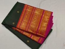 Vaibhogam- Gorgeous Bottle Green with Orange Handwoven Pure Jari Korvai Kanjivaram Silk with beautiful buttas woven body with rich varisaipet borders beautiful pallu and contrast woven blouse with Pink  selvedges