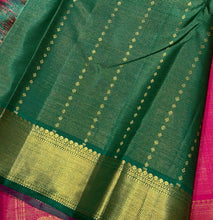 Vaibhogam- Gorgeous Dual tone Burnt Orange Pink with Green Vairaoosi with Buttas Handwoven Pure Jari Kanjivaram Silk with beautiful double Peacock motifs woven body with rich borders with green selvedges beautiful pallu contrast woven green blouse