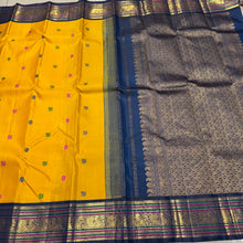Vaibhogam-Gorgeous Yellow with Deep Sapphire Blue Handwoven Pure Jari Korvai Kanjivaram Silk with Pattu Buttas Woven Body with Rich and Intricate Meenakari work Borders Gorgeous Pallu and Contrast Woven Blouse