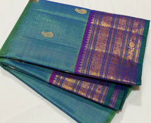 Sahana- Gorgeous Peacock Bluish Green with Purple Handwoven Pure Jari Kanjivaram Silk with Vairaoosi with buttas woven beautiful body with varisaipet borders with green selvedges rich pallu and contrast woven blouse