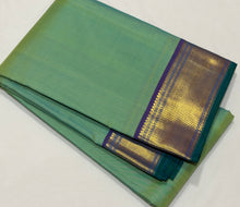 Nayaki- Gorgeous Pastel Green with Double tone Blue Handwoven Pure Kanjivaram Silk with beautiful bawanchi borders with rich pallu and contrast woven blouse